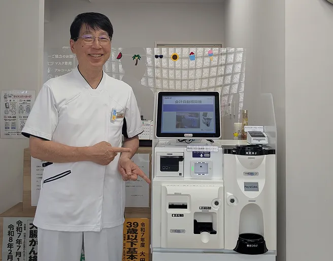医師が導入された自動精算機を案内している様子